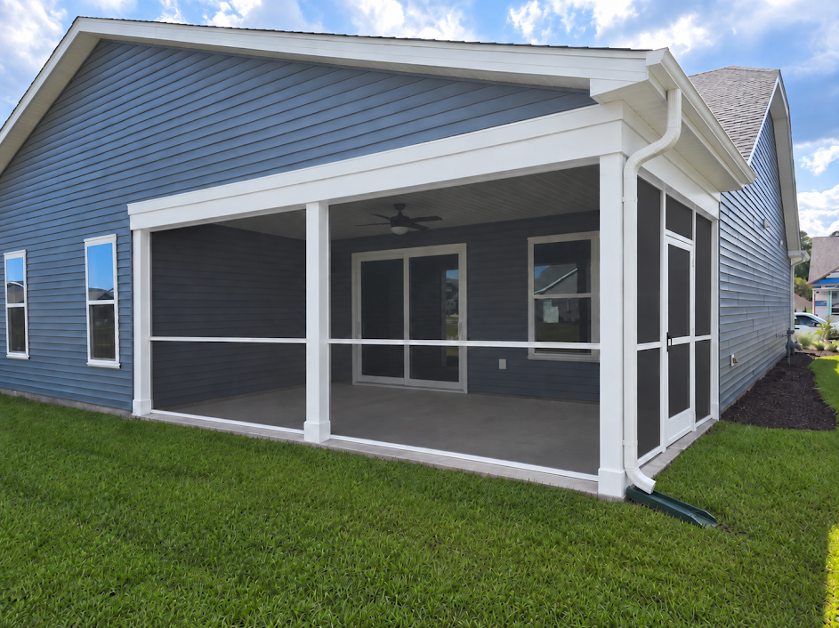 Completed screened porch with white frame on a blue home